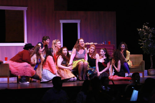 Photo of the chorus girls surrounding Adina in 'l'Elisir d'Amore'.